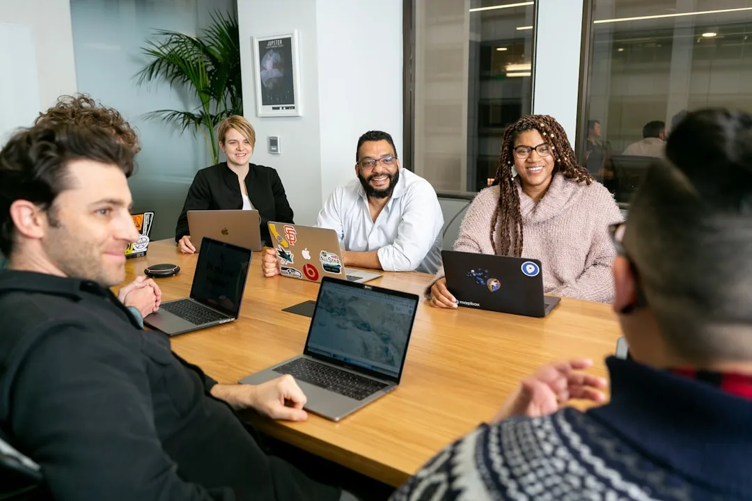 Diverse Kyool professionals working together to build the fitness accountability app