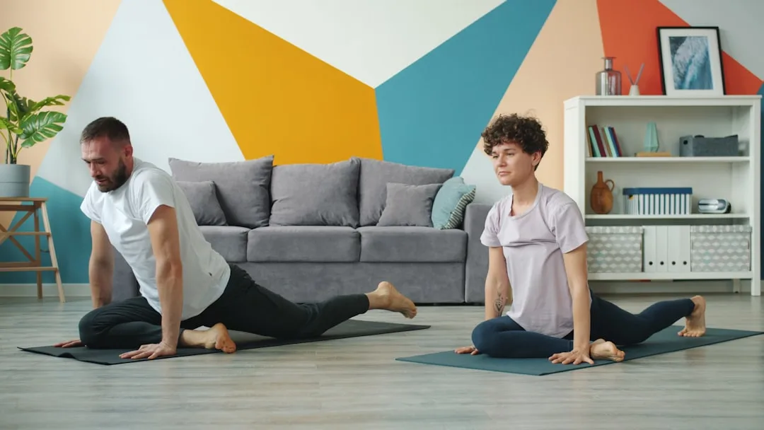 Woman doing yoga at home as part of her Kyool fitness accountability routine